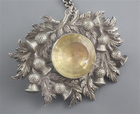 A 19th century Scottish white metal and citrine set cloak badge on chain, 9.5cm.